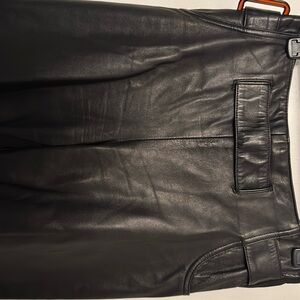 Leather pants on front side and the back has stretchy material .
